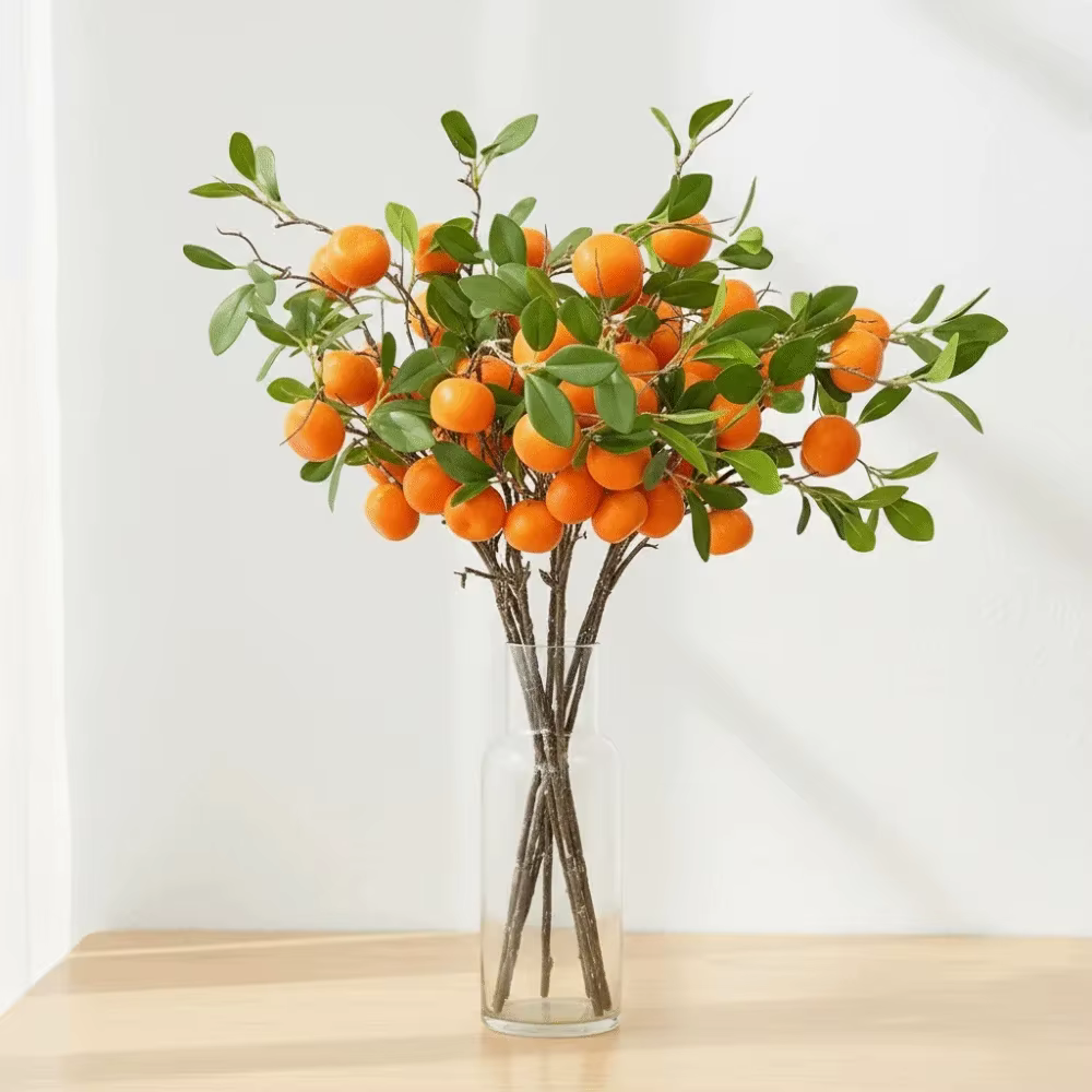 Branche d'orange artificielle avec feuilles vertes réalistes