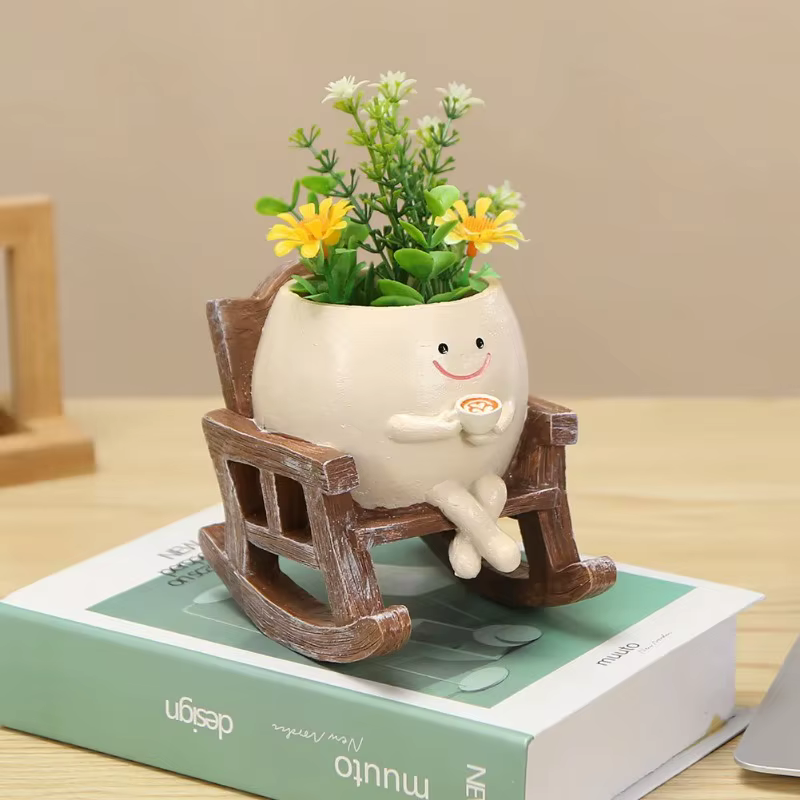 Pot de fleurs créatif en forme de tête de personne assise sur une balançoire